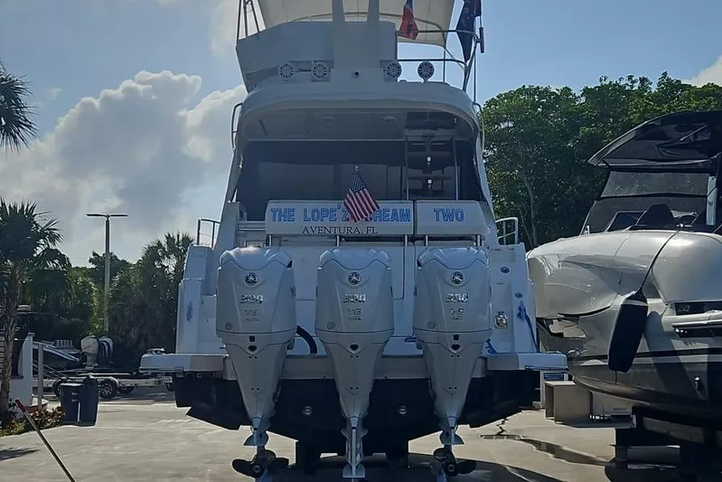  Yacht Photos Pics 2023 Regal 38 FXO yacht with triple outboard engines, docked in Aventura, Florida.