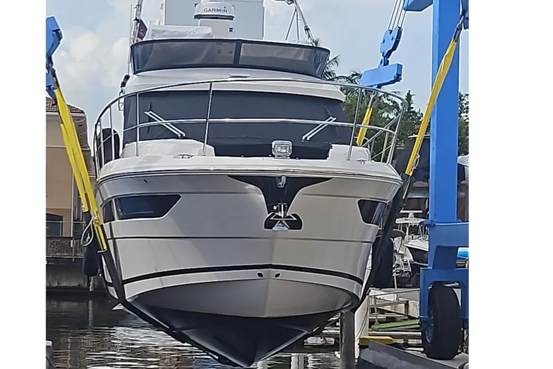  Yacht Photos Pics 2023 Regal 38 FXO yacht in dry dock, front view, with lifting straps.