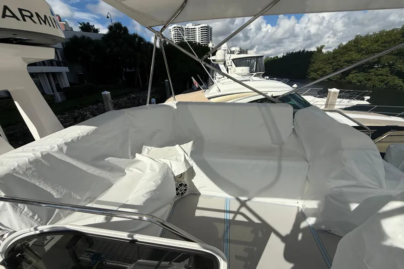  Yacht Photos Pics 2023 Regal 38 FXO yacht with covered seating area at a marina.