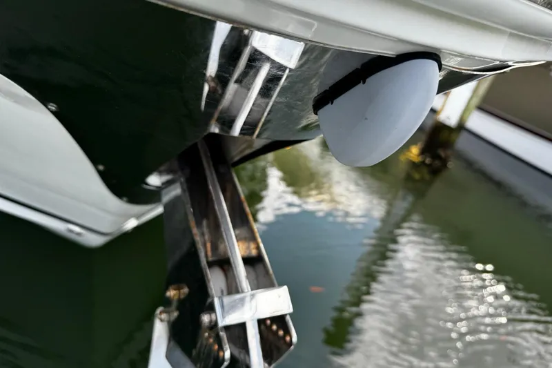  Yacht Photos Pics Close-up of 2023 Regal 38 FXO boat anchor mechanism above water.
