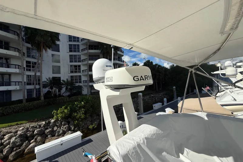  Yacht Photos Pics 2023 Regal 38 FXO yacht with Garmin radar, docked near waterfront buildings.