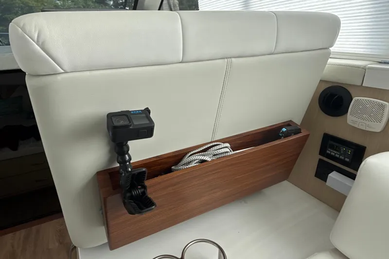  Yacht Photos Pics 2023 Regal 38 FXO interior with white seating, wood accents, and mounted camera.