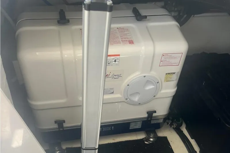  Yacht Photos Pics Engine compartment of 2023 Regal 38 FXO boat, featuring a white generator unit.