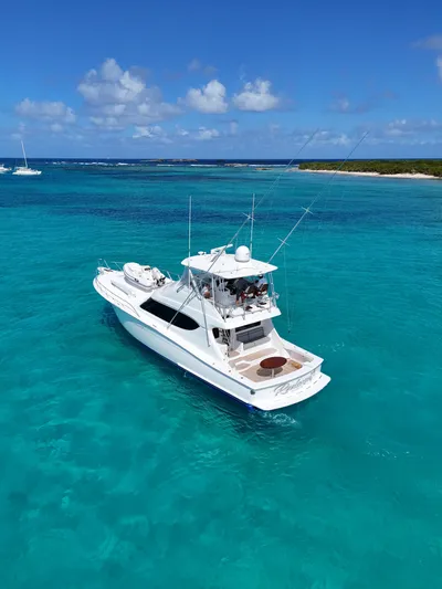  Yacht Photos Pics 2011 Hatteras GT60 yacht cruising in clear turquoise waters under a bright blue sky.