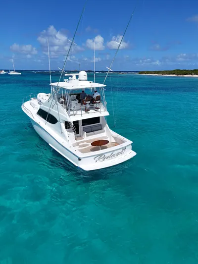  Yacht Photos Pics 2011 Hatteras GT60 yacht on turquoise waters under a clear blue sky.