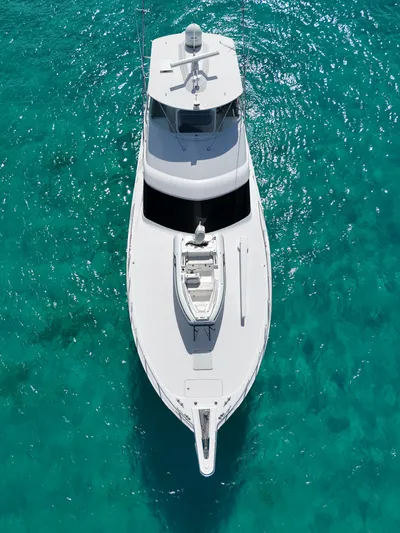  Yacht Photos Pics Aerial view of 2011 Hatteras GT60 yacht on clear turquoise water.