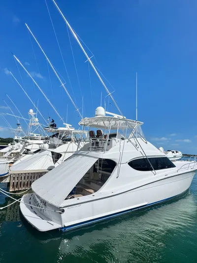  Yacht Photos Pics 2011 Hatteras GT60 yacht docked in marina under clear blue sky.