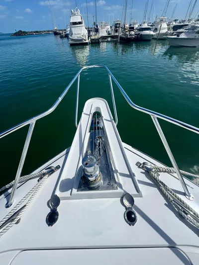  Yacht Photos Pics Bow view of 2011 Hatteras GT60 yacht docked in marina, surrounded by boats.