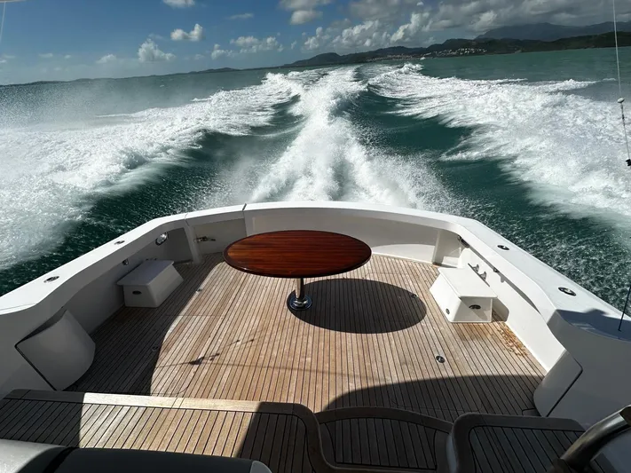  Yacht Photos Pics Hatteras GT60 yacht cruising, 2011 model, with wooden deck and ocean view.
