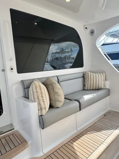  Yacht Photos Pics 2011 Hatteras GT60 yacht interior with cushioned seating and decorative pillows.