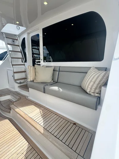  Yacht Photos Pics 2011 Hatteras GT60 yacht interior with cushioned seating and wooden flooring.