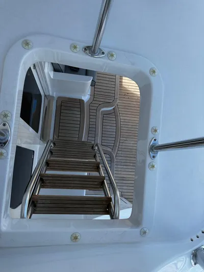  Yacht Photos Pics Stairway on 2011 Hatteras GT60 yacht with wooden deck and metal railings.