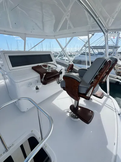  Yacht Photos Pics 2011 Hatteras GT60 yacht helm with luxurious seating and control panel.