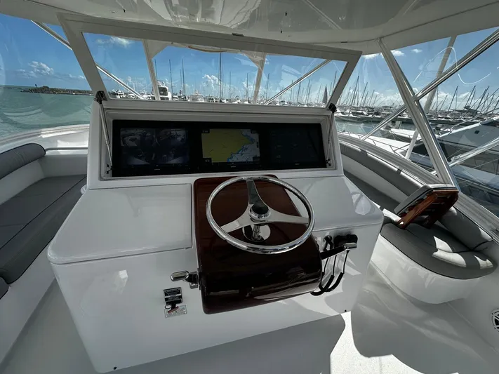  Yacht Photos Pics Helm of 2011 Hatteras GT60 yacht with steering wheel and navigation screens.