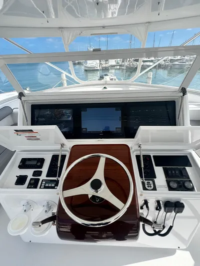  Yacht Photos Pics Helm of 2011 Hatteras GT60 yacht with modern navigation equipment and steering wheel.