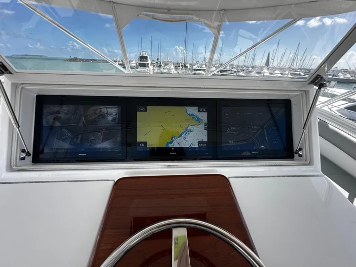  Yacht Photos Pics Helm of 2011 Hatteras GT60 yacht with navigation screens and marina view.