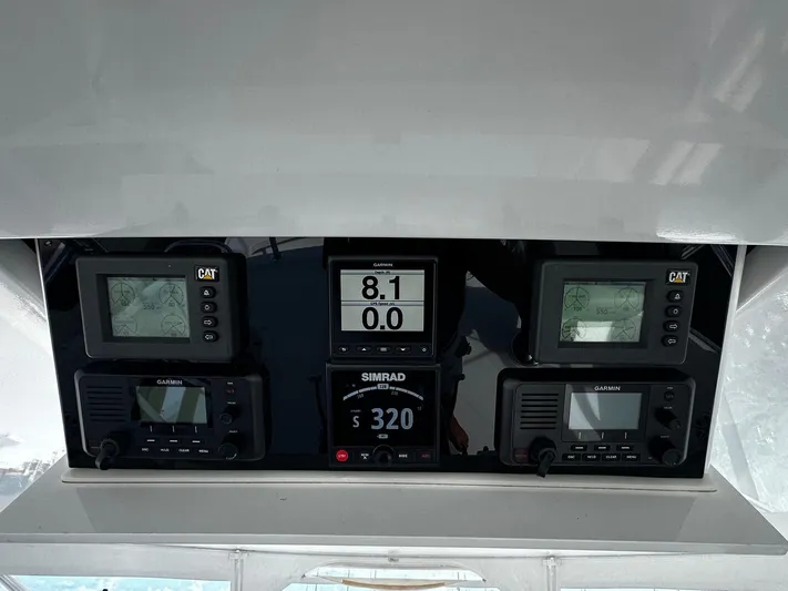  Yacht Photos Pics Control panel of a 2011 Hatteras GT60 yacht with navigation and monitoring displays.