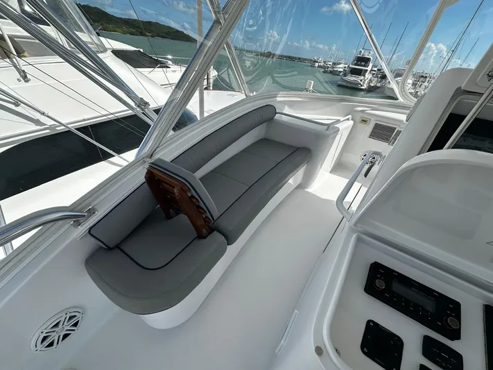  Yacht Photos Pics 2011 Hatteras GT60 yacht cockpit with gray seating and marina view.