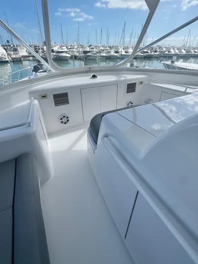  Yacht Photos Pics 2011 Hatteras GT60 yacht interior with marina view, featuring sleek white design and seating.