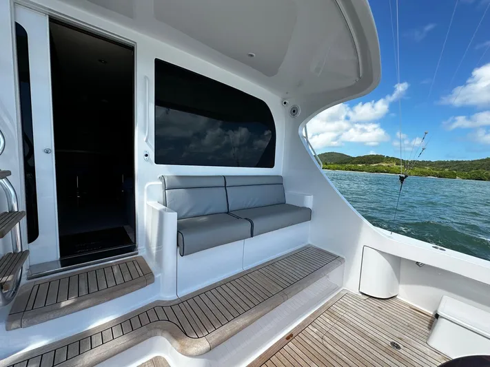  Yacht Photos Pics 2011 Hatteras GT60 yacht deck with seating, overlooking serene waters and lush landscape.