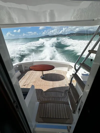  Yacht Photos Pics 2011 Hatteras GT60 yacht cruising, view from deck with ocean waves and clear sky.