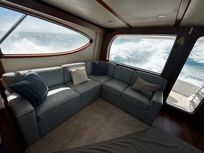  Yacht Photos Pics Luxurious interior of 2011 Hatteras GT60 yacht with ocean view through large windows.