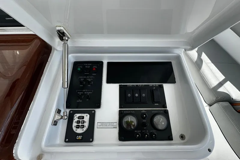  Yacht Photos Pics Control panel of a 2011 Hatteras GT60 yacht, featuring various switches and gauges.