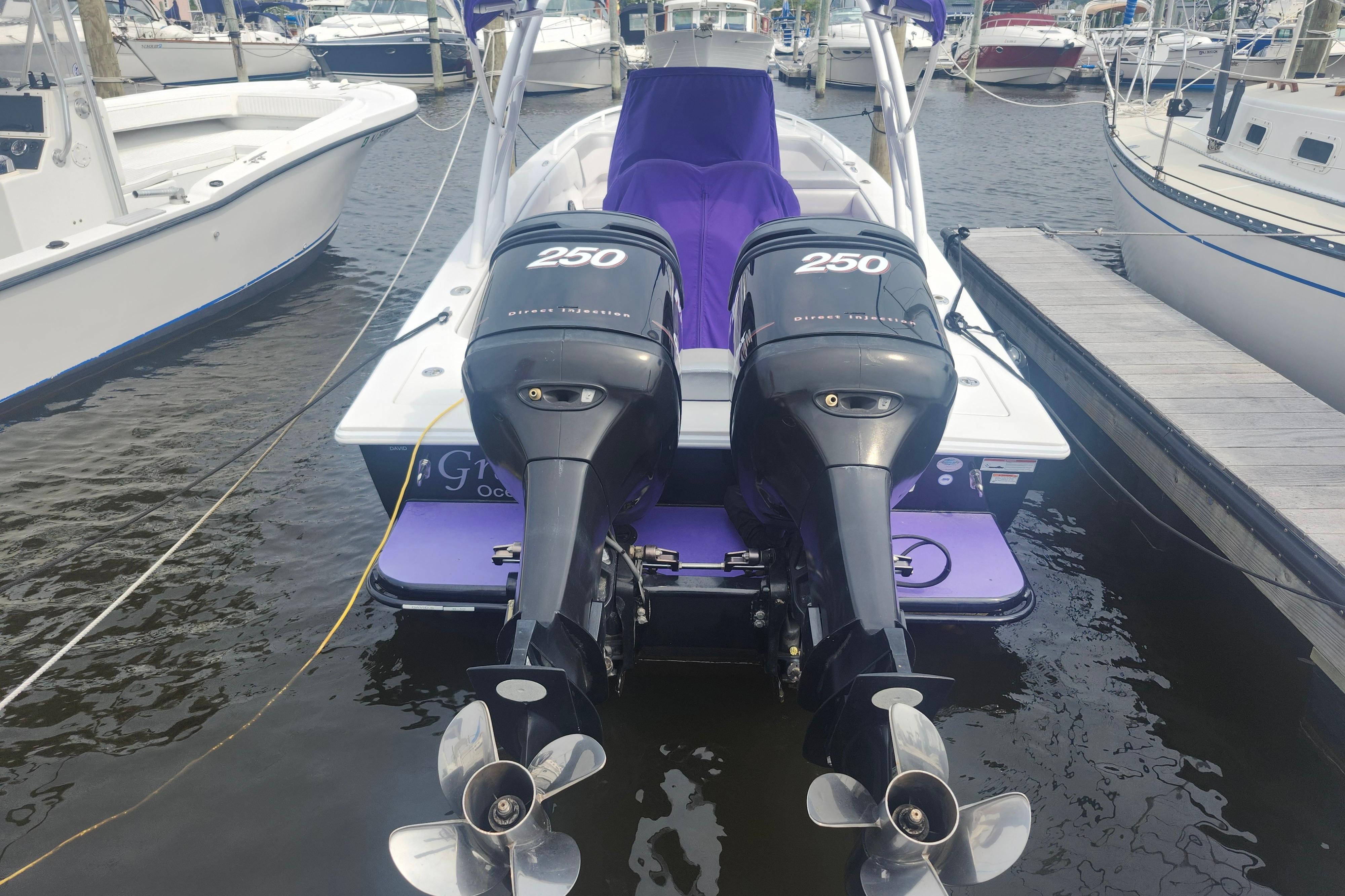 2014 Concept 30 Cuddy boat with twin 250 horsepower engines docked at marina.