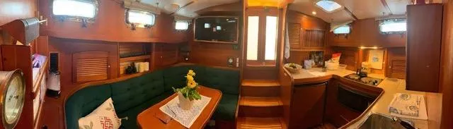  Yacht Photos Pics Interior of 1999 Sabreline 36 Express yacht with wood finish and cozy seating area.