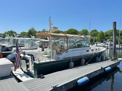  Yacht Photos Pics 1999 Sabreline 36 Express docked at marina, sunny day, surrounded by other boats.