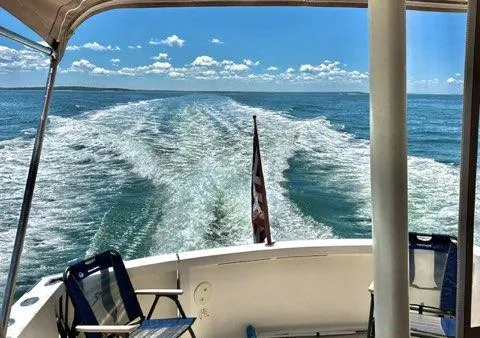  Yacht Photos Pics 1999 Sabreline 36 Express cruising on open water, leaving a wake behind.