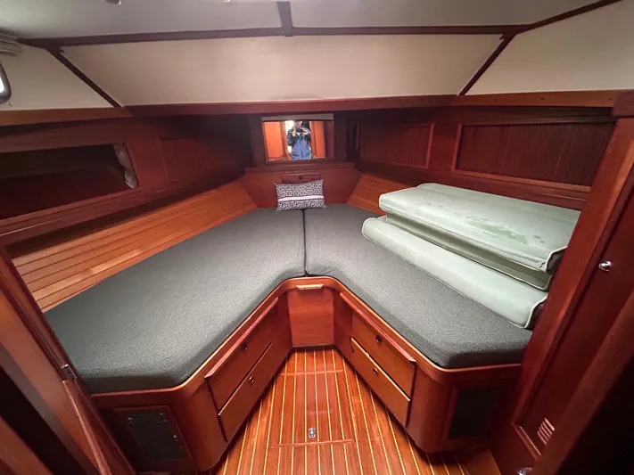  Yacht Photos Pics Cozy cabin interior of 1999 Sabreline 36 Express with wooden finish and cushioned seating.