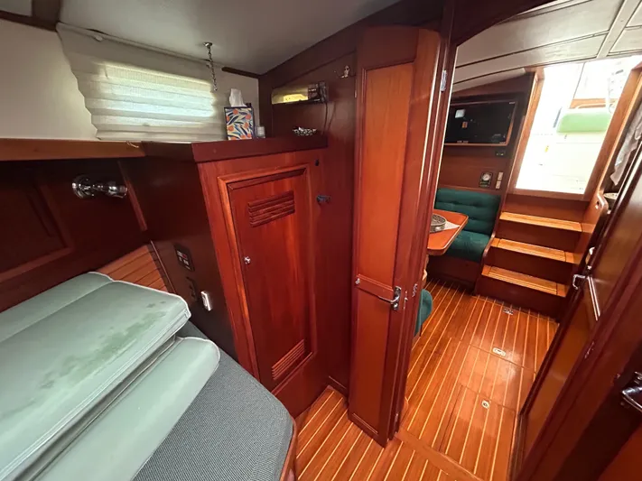  Yacht Photos Pics 1999 Sabreline 36 Express yacht interior with wooden cabinetry and seating area.