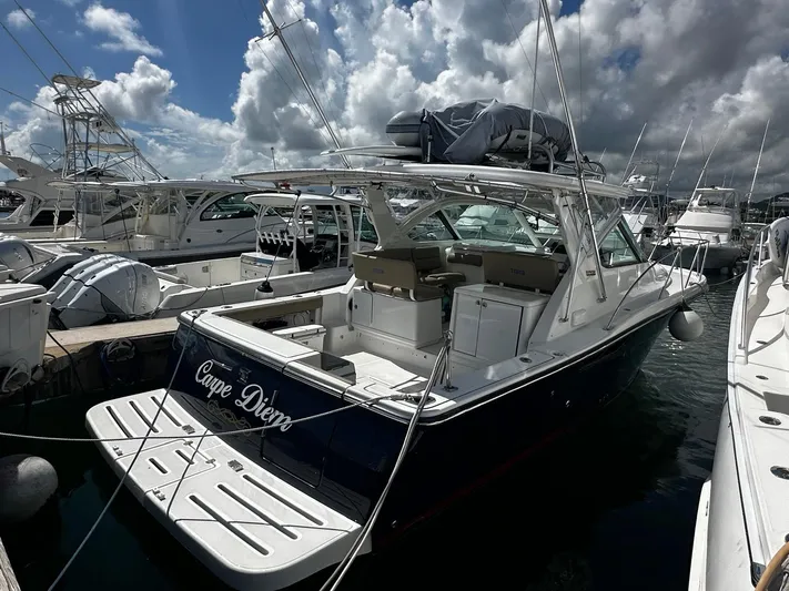  Yacht Photos Pics 2005 Tiara Yachts 3200 Open docked under cloudy skies.
