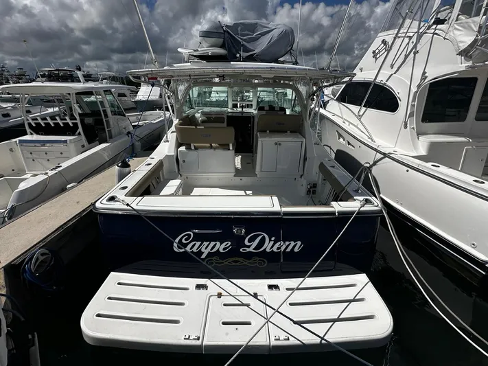  Yacht Photos Pics 2005 Tiara Yachts 3200 Open, "Carpe Diem," docked at marina under cloudy sky.