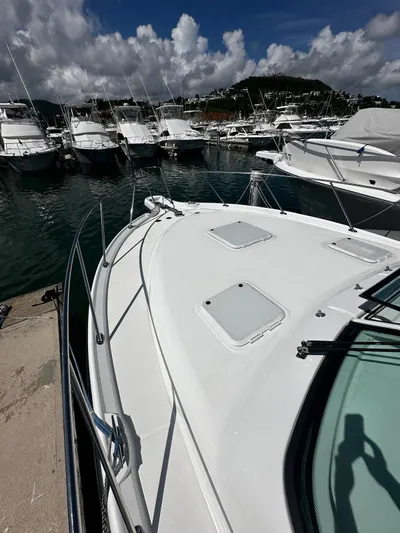  Yacht Photos Pics 2005 Tiara Yachts 3200 Open docked in a marina under cloudy skies.