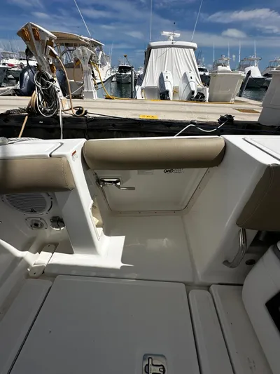  Yacht Photos Pics 2005 Tiara Yachts 3200 Open at marina, showcasing cockpit seating and docked boats.