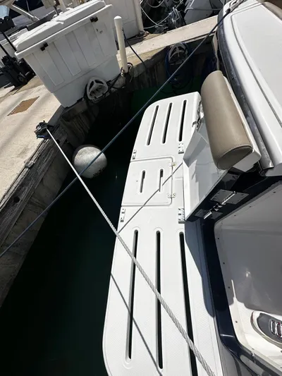  Yacht Photos Pics 2005 Tiara Yachts 3200 Open docked with swim platform and mooring lines.