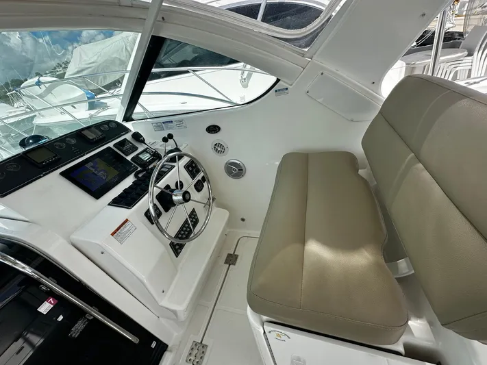  Yacht Photos Pics 2005 Tiara Yachts 3200 Open helm with beige seating and modern controls.