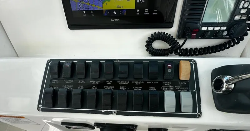  Yacht Photos Pics Control panel of a 2005 Tiara Yachts 3200 Open, featuring switches and navigation equipment.