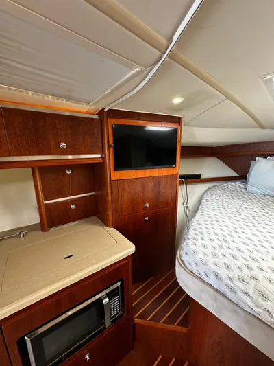 Yacht Photos Pics 2005 Tiara Yachts 3200 Open cabin interior with bed, TV, and microwave.