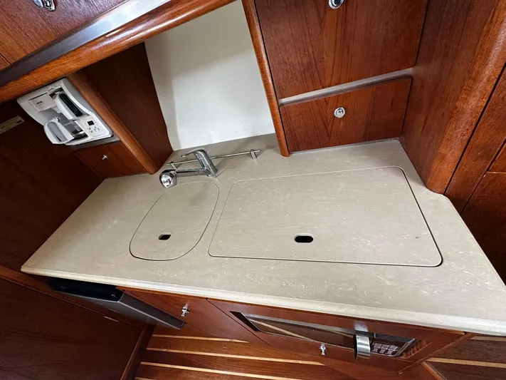  Yacht Photos Pics 2005 Tiara Yachts 3200 Open galley with wooden cabinetry and sleek countertop.