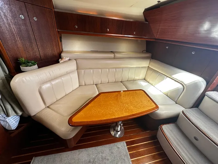  Yacht Photos Pics Luxurious interior of 2005 Tiara Yachts 3200 Open with plush seating and wooden table.
