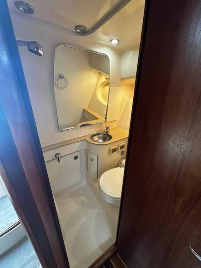  Yacht Photos Pics 2005 Tiara Yachts 3200 Open bathroom with sink, mirror, and toilet.