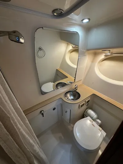  Yacht Photos Pics 2005 Tiara Yachts 3200 Open bathroom with sink, mirror, and toilet.