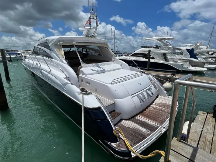 Mat Yacht Photos Pics 2009 Princess V58 yacht docked at marina under cloudy sky.
