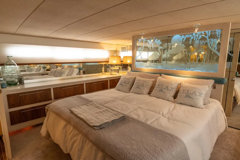 Tenacity Yacht Photos Pics Luxurious bedroom in a 1986 Bertram 58 Flybridge Motor Yacht with elegant decor.