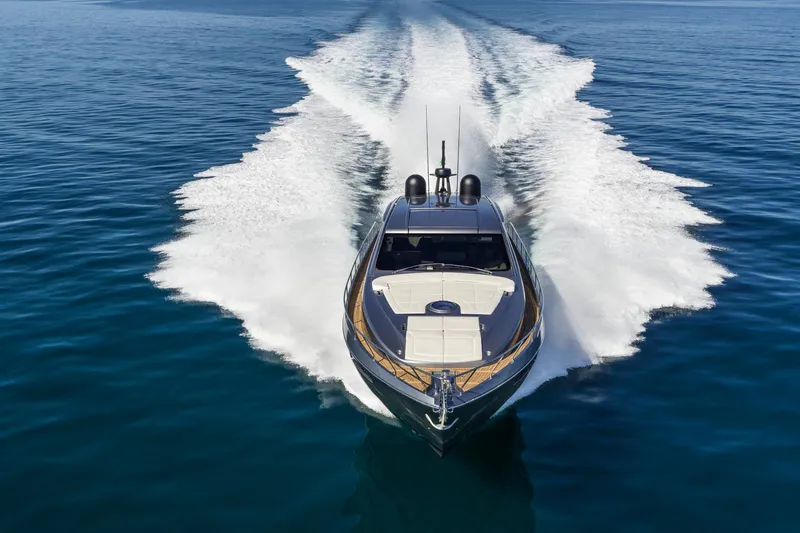 Our Trade Yacht Photos Pics 2023 Pershing 6X yacht cruising on open water, creating a dynamic wake.