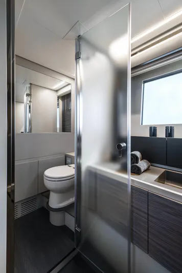Our Trade Yacht Photos Pics Luxurious bathroom in 2023 Pershing 6X yacht with modern fixtures and sleek design.