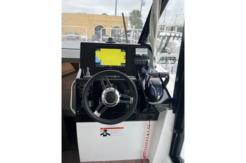  Yacht Photos Pics 2025 Jeanneau NC 895 Sport Series 2 helm with modern navigation controls and steering wheel.